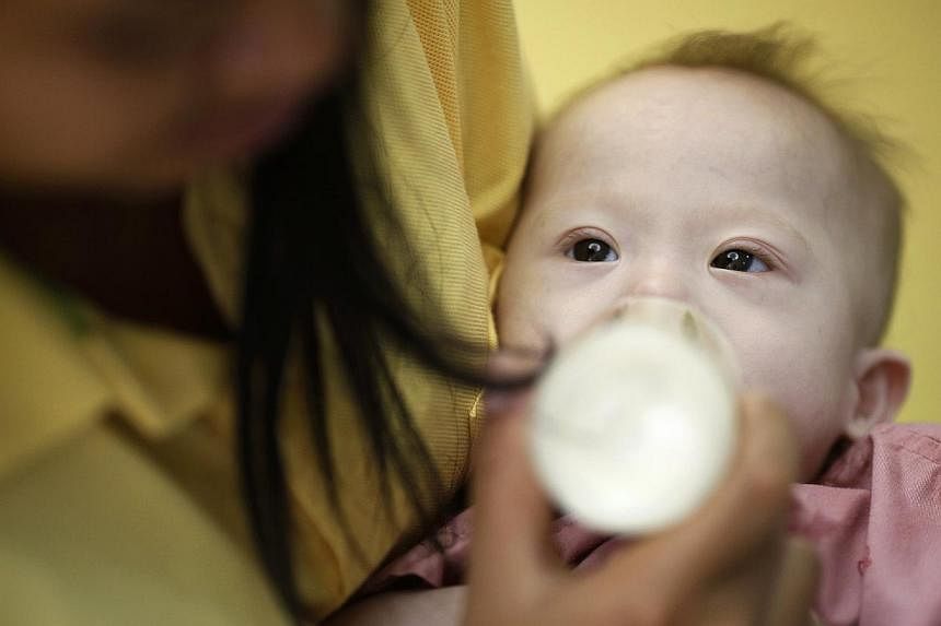 Gammy, a baby born with Down's Syndrome, is fed by his surrogate mother Pattaramon Janbua at a hospital in Chonburi province August 3, 2014. -- PHOTO: REUTERS