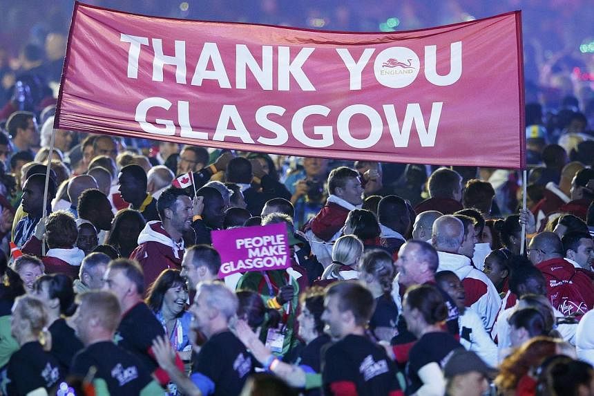 A banner is held up among athletes attending the closing ceremony of the 2014 Commonwealth Games at Hampden Park in Glasgow, Scotland on Aug 3, 2014. -- PHOTO: REUTERS