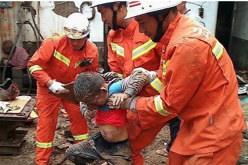 Rescue workers evacuate a boy dug out from under the debris of collapsed houses,&nbsp;after a magnitude 6.3 earthquake hit Longtoushan town, Ludian county, Zhaotong, Yunnan province, August 4, 2014.&nbsp;An intense rescue operation was under way in C