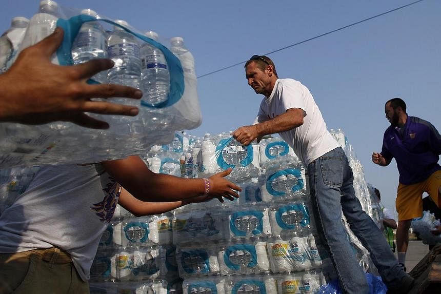 Volunteers unload drinking water from a truck outside Waite High School in Toledo, Ohio, on Aug 3, 2014.&nbsp;Hundreds of thousands of residents entered a third day on Monday, Aug 4, unable to drink their tap water after officials warned that the sup
