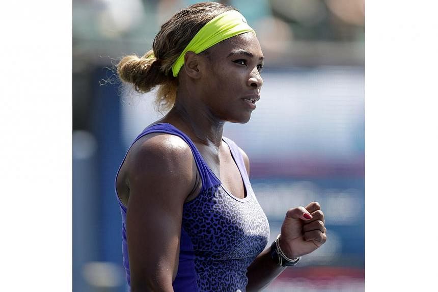 Serena Williams of the USA reacts after winning the first set of her match against Angelique Kerber of Germany in the finals of the Bank of the West Classic at the Taube Family Tennis Stadium in Stanford, California on Aug 3, 2014. -- PHOTO: AFP