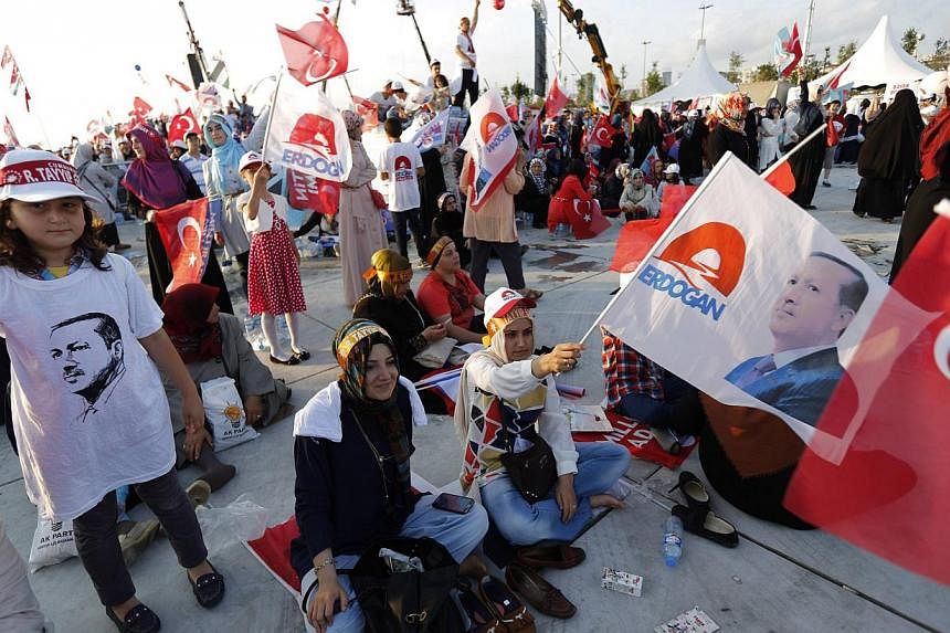 Supporters of Turkey's Prime Minister and presidential candidate Recep Tayyip Erdogan&nbsp;wave flags during an election rally in Istanbul on August 3, 2014. Turkey will vote for its first directly-elected president on August 10. -- PHOTO: REUTERS