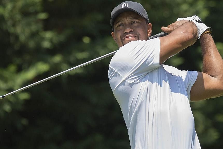 A file picture taken on June 27, 2014 shows US golfer Tiger Woods teeing off during the second round of the Quicken Loans National at Congressional Country Club in Bethesda, Maryland. Former world No. 1 Woods withdrew from the final round of the Worl