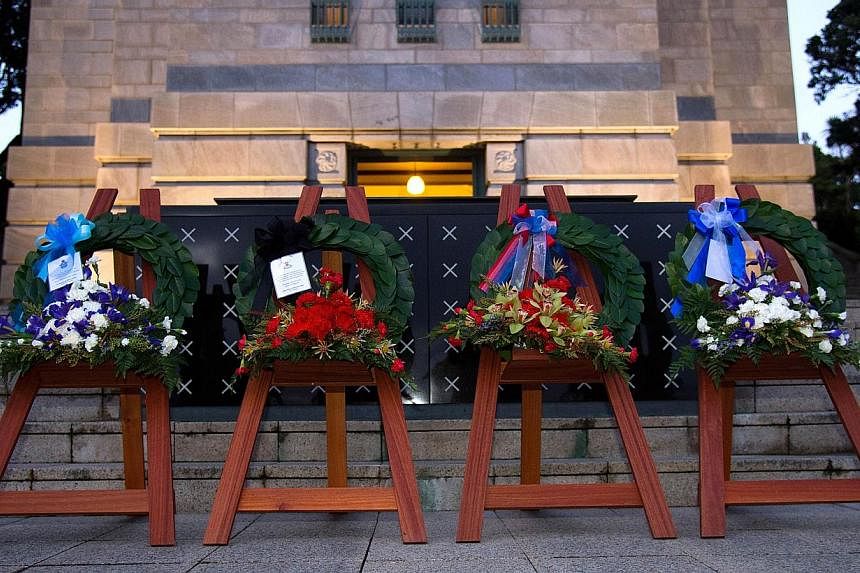 Wreaths placed at the Tomb of the Unknown Warrior by New Zealand's Army, Air Force, Navy and Defence department during ceremonies on Aug 4, 2014 in Wellington commemorating the 100th anniversary of the start of World War I. -- PHOTO: AFP