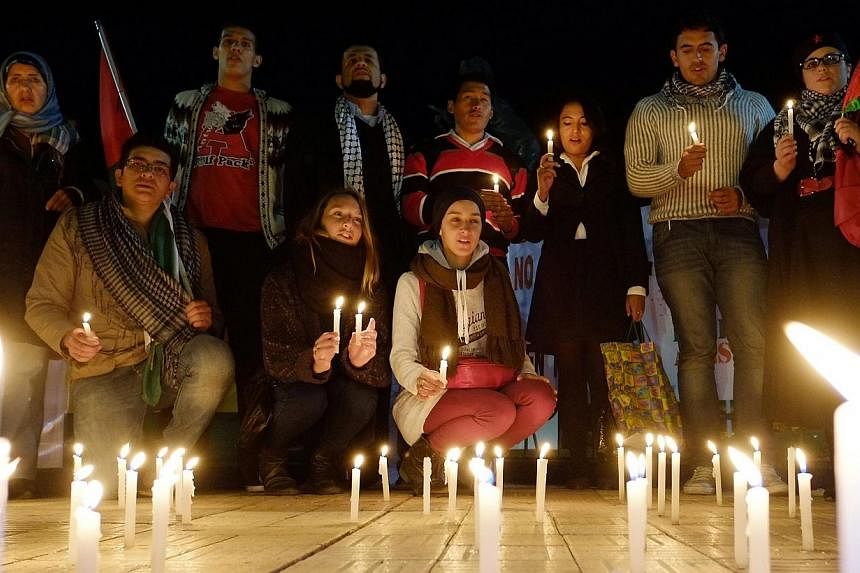 Palestinians living in Bolivia and other supporters participate in a candlelight vigil to demonstrate their solidarity with those living in Gaza, in La Paz, on Aug 4, 2014. -- PHOTO: REUTERS