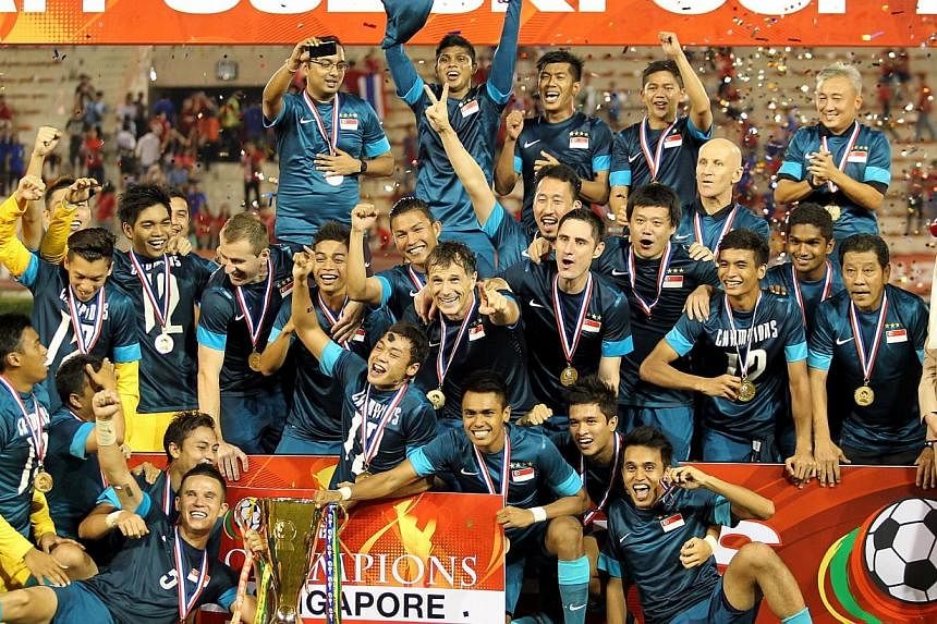 The Singapore football team celebrates after winning the AFF Suzuki Cup final against Thailand at the Supachalasi Stadium in Bangkok on Dec 22, 2012. Co-hosts Singapore have been drawn to face Malaysia, three-time champions Thailand and the qualifyin