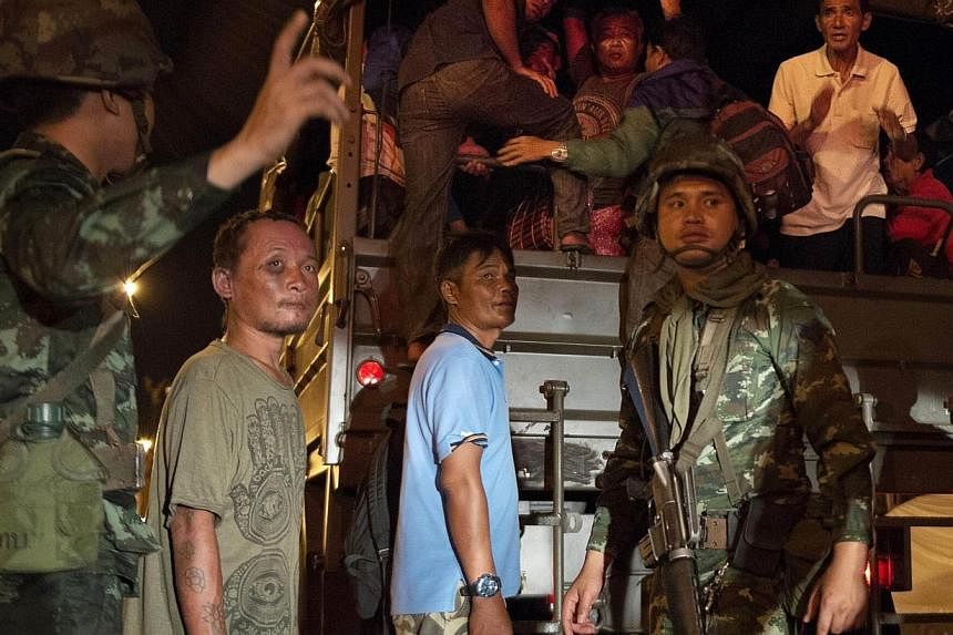 Pro-government ''Red shirt'' activists leave their protest rally venue on an army truck after it was shut it down by the Thai army and cleared of all protesters, after Thailand's army chief announced that the armed forces were seizing power, on the o