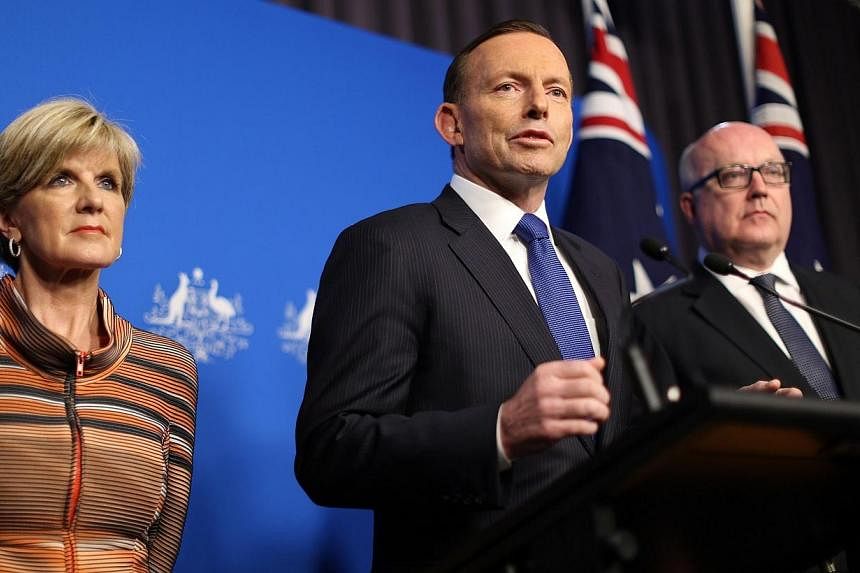 Prime Minister Tony Abbott (centre) speaks at a joint press conference with Foreign Minister Julie Bishop and Attorney General George Brandis (right) in Canberra on Tuesday, Aug 5, 2014.&nbsp;Australia will toughen laws to target home-grown terrorist