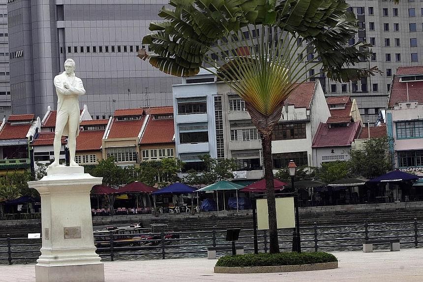 The Sir Stamford Raffles statue along the Singapore River will be boarded up on Wednesday and Thursday for its regular cleaning. -- PHOTO: ST FILE&nbsp;