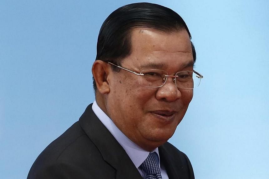 Mr Hun Sen (above) showed off Cambodia's future leader in Thailand.