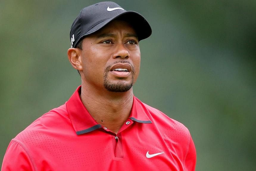 Tiger Woods looks on after hitting off the fourth tee during the final round of the World Golf Championships-Bridgestone Invitational at Firestone Country Club South Course in Akron, Ohio&nbsp;on August 3, 2014. -- PHOTO: AFP