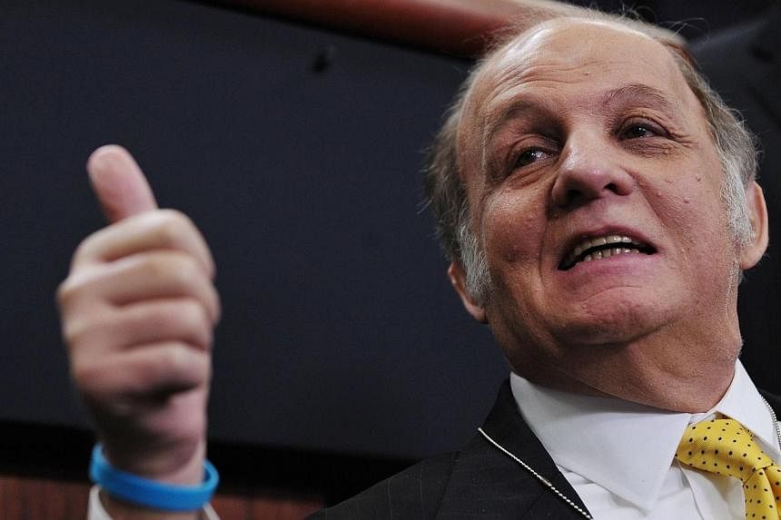 A March 30, 2011 file photo shows former White House press secretary James Brady as he gives the thumbs-up while visiting the Brady Briefing Room at the White House in Washington, DC. He was shot and left permanently disabled in an assassination atte