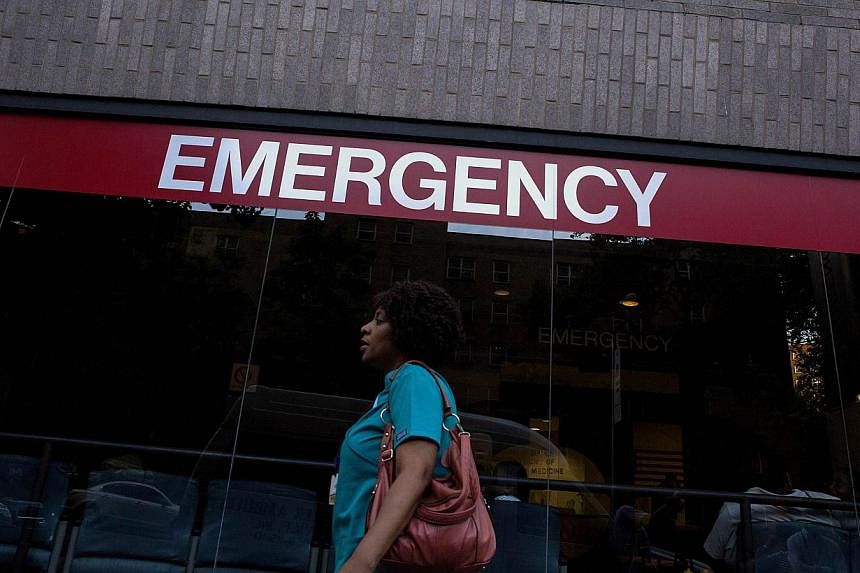A woman walks in front of Mount Sinai Hospital on Aug 4, 2014, in New York City. The second American aid worker who contracted the Ebola virus in West Africa is expected to arrive in Atlanta on Tuesday in serious condition, while the hospital is test