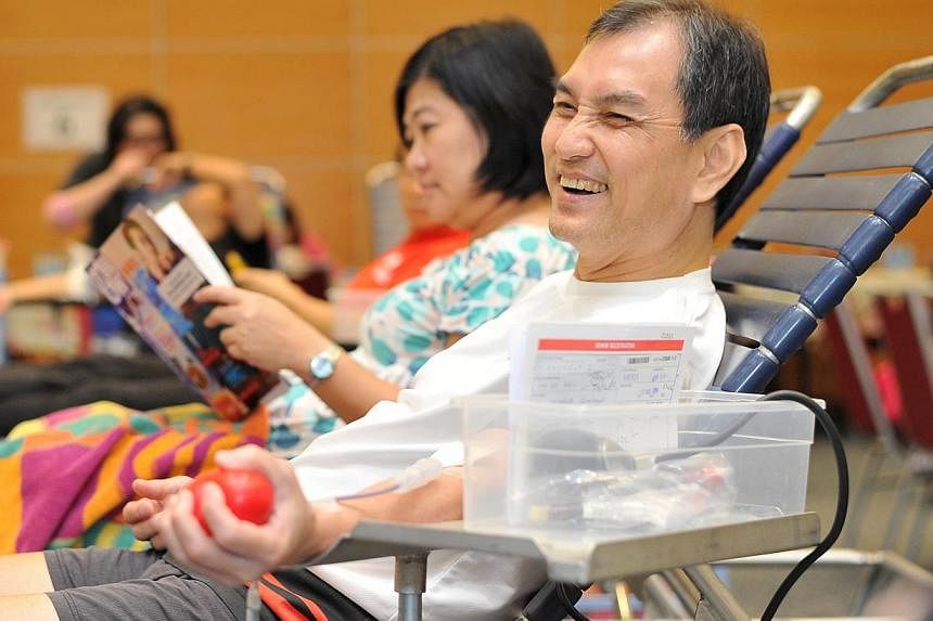 Mr Lim Jit Siew, 59, Financial Consultant, at SPH Red Apple Day, on Aug 05 2014.&nbsp;-- ST PHOTO: LIM YAOHUI FOR THE STRAITS TIMES