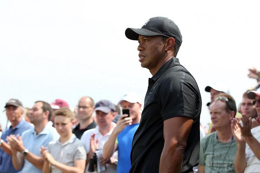 US golfer Tiger Woods, seen here at the British Open Golf Championship in July, withdrew from the&nbsp;World Golf Championships event in Akron, Ohio&nbsp;on Sunday due to a painful back. -- PHOTO: AFP