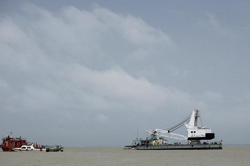 Bangladeshi rescue teams search the waters where an overloaded ferry capsized the day before in the Padma river in Munshiganj, some 30km south of the capital Dhaka, on Aug 5, 2014. -- PHOTO: AFP
