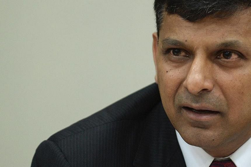 Reserve Bank of India (RBI) governor Raghuram Rajan speaks during a news conference at RBI headquarters in Mumbai on August 5, 2014. Mr Rajan says global markets are at risk of a "crash" should investors start bailing out of risky assets created by t