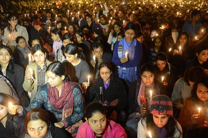 Indian protestors hold candles during a rally in New Delhi, after the death of a gang rape student from the Indian capital on Dec 29, 2012. -- PHOTO: AFP