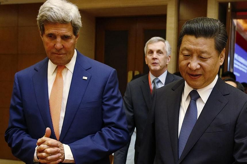 US Secretary of State John Kerry and Chinese President Xi Jinping after the Joint Opening Session of the US-China Strategic and Economic Dialogue in Beijing last month. While the US seeks to sustain its dominance as the world's sole superpower, China