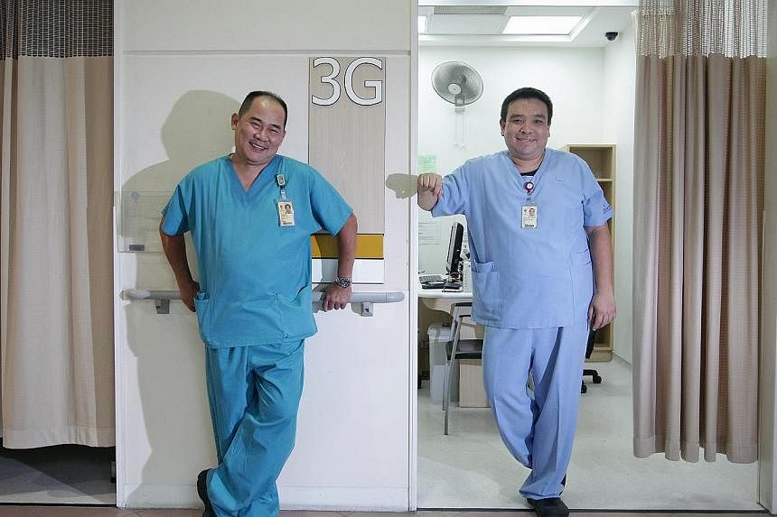 Tan Tock Seng Hospital nurses Christopher Lee (left) and Christopher Soh. Mr Lee works in the orthopaedic department, while Mr Soh works in the emergency department. The additional demand for nurses each year is projected to be about 1,400 until 2020