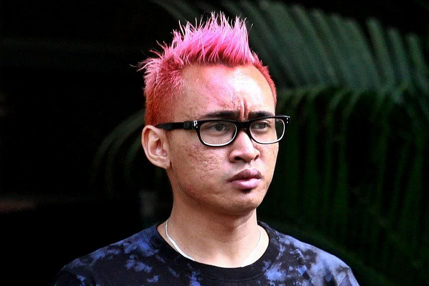 Muhammad Qamarul Arifin Sa'adon, 23, who sprayed anti-government graffiti on a pavement, was jailed for two months and ordered to be given three strokes of the cane on Thursday. -- ST PHOTO: LAU FOOK KONG