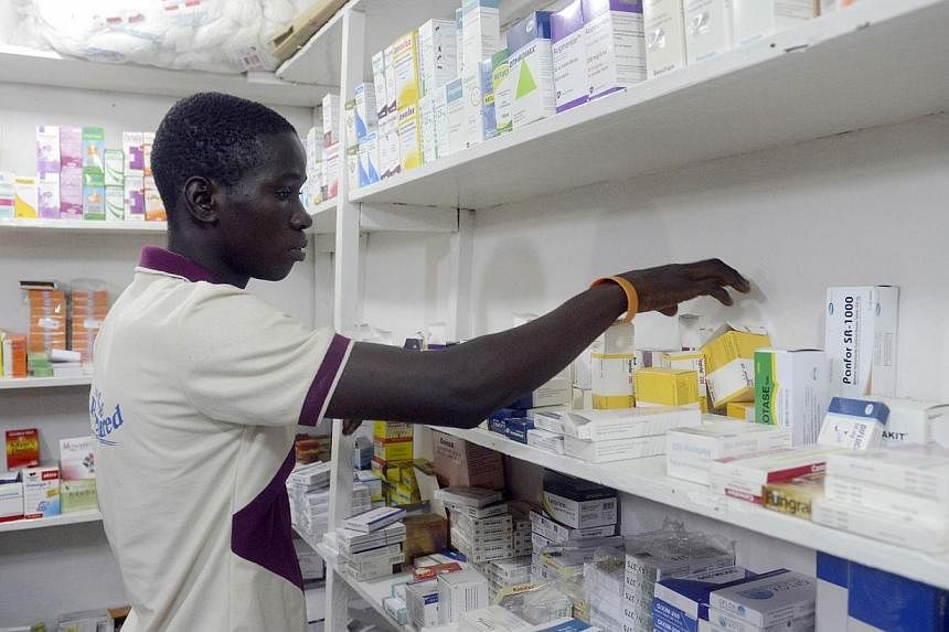 A pharmacist searches for drugs in a pharmacy in Lagos on July 26, 2014.&nbsp;With hundreds of patients in Africa suffering the devastating effects of Ebola, health experts are scrambling to determine which drugs might offer the best experimental tre