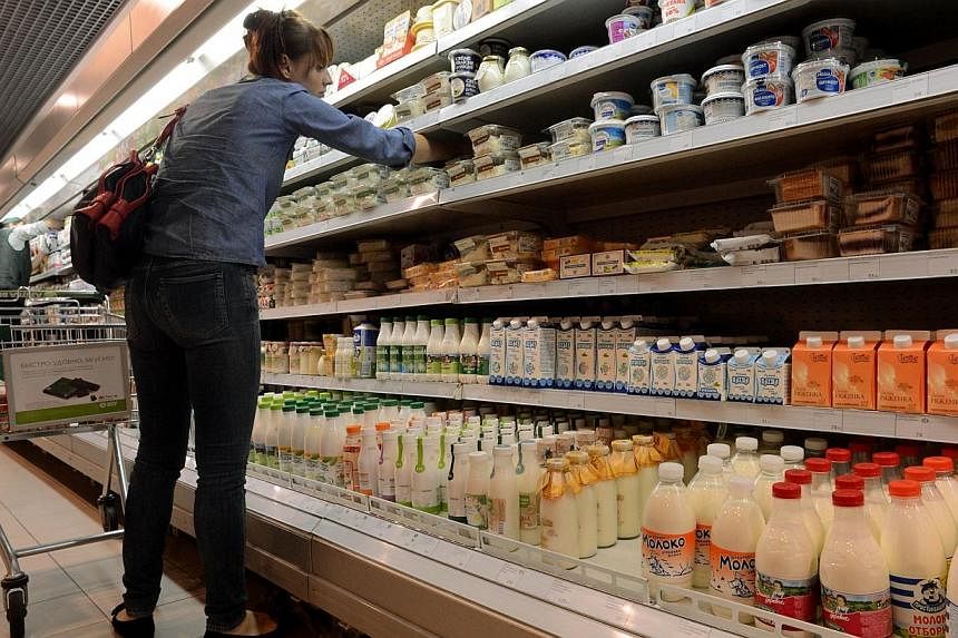 A file picture taken on Aug 5, 2013 shows a woman looking at dairy products in a supermarket in central Moscow.&nbsp;Russia is introducing a "full embargo" on most food imports from EU, US, and other Western countries that have imposed sanctions agai
