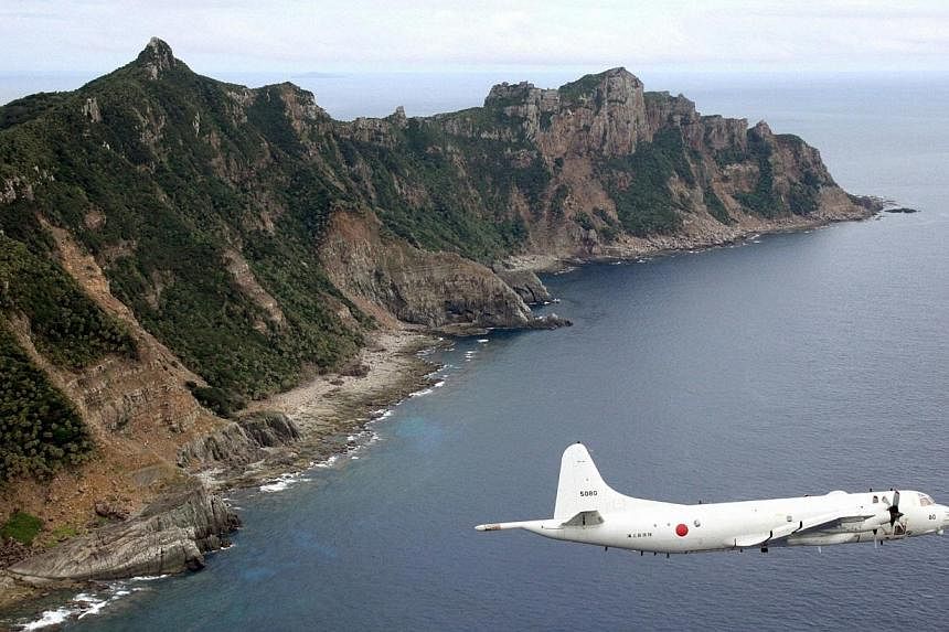 A Japan Maritime Self-Defense Force's PC3 surveillance plane flies around the disputed islands in the East China Sea, known as Senkaku in Japan and Diaoyu in China on Oct 13, 2011.&nbsp;Japanese fighter jets shadowed Chinese aircraft patrolling over 