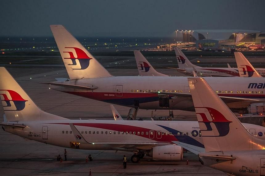 Ground staff prepare Malaysia Airlines planes for departure at Kuala Lumpur International Airport in Sepang on July 30, 2014. Malaysia Airlines plans to suspend its shares from trading on Friday, two sources familiar with the situation said, likely p