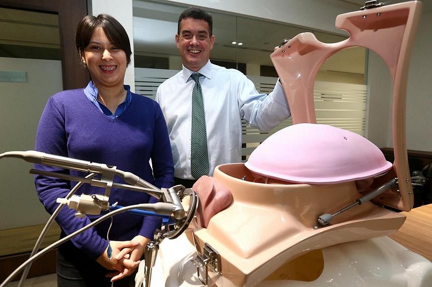 Ms Vargilia Bridget Welford, 27, and Dr Peter Barton-Smith at a demonstration of how ViKY works. Ms Welford underwent surgery in March for endometriosis using ViKY and took just half the time to recover.
