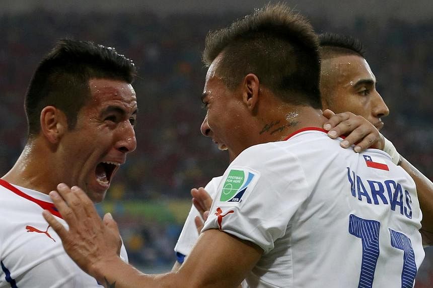 Mauricio Isla, Eduardo Vargas and Arturo Vidal (left to right) celebrating a goal for Chile during the 2014 World Cup. Isla, who plays for Juventus, was signed to Premier League new-boys QPR on a season-long loan on Wednesday. -- PHOTO:&nbsp;REUTERS