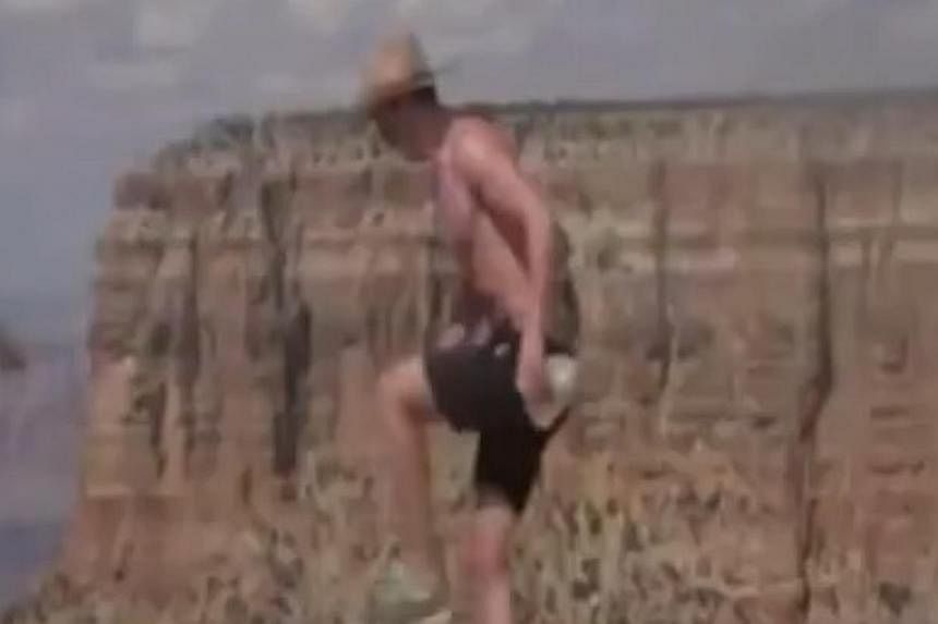 A still from a video which went viral online of a&nbsp;shirtless man seen kicking a squirrel off the edge of the Grand Canyon. A reward of US$15,000 (S$18,000) is being offered by animal rights group PETA&nbsp;for information leading to the arrest of