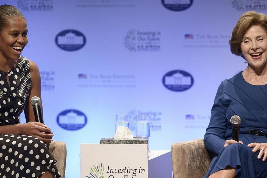 US first lady Michelle Obama (left) and former US first lady Laura Bush speak during a panel discussion during "Investing in Our Future" at the US-Africa Leaders Summit at the Kennedy Centre on August 6, 2014 in Washington, DC. Michelle Obama and Lau