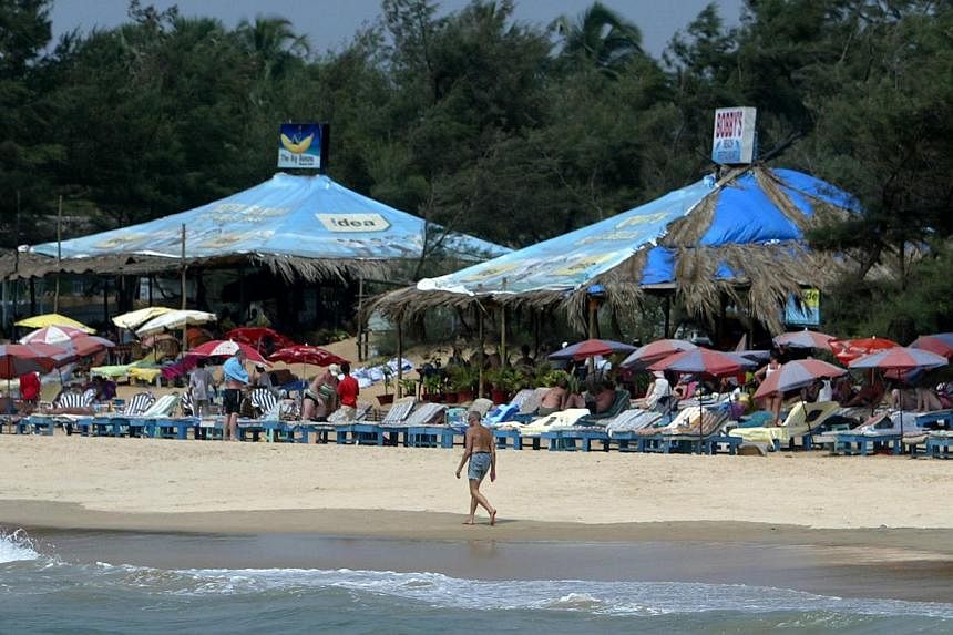 A tourist walks past a row of sunbeds on Baga Beach in Goa&nbsp;on March 14, 2008.&nbsp;The Indian state of Goa is setting up a detention centre specifically for foreigners who overstay their welcome in the popular coastal spot, a top official said. 