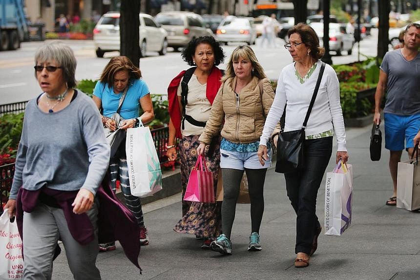 Shoppers visit stores along a section of Michigan Avenue known as the Magnificent Mile on July 29, 2014 in Chicago, Illinois.&nbsp;The US trade deficit shrank in June primarily on lower imports. -- PHOTO: AFP