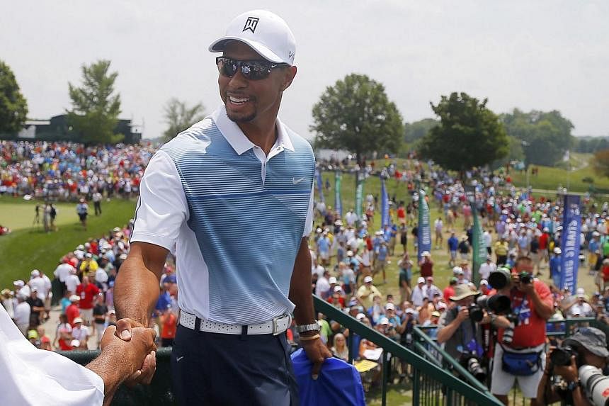 Golfer Tiger Woods of the United States is greeted as he walks to the practice range at the 2014 PGA Championship at Valhalla Golf Course in Louisville, Kentucky on August 6, 2014. -- PHOTO: REUTERS