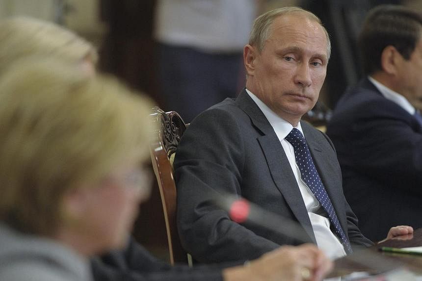 Russia's President Vladimir Putin chairing a session of the State Council Presidium in Voronezh on August 5, 2014. Putin has ordered his government to come up with a list of goods to be banned for imports into Russia and to last one year, the Kremlin