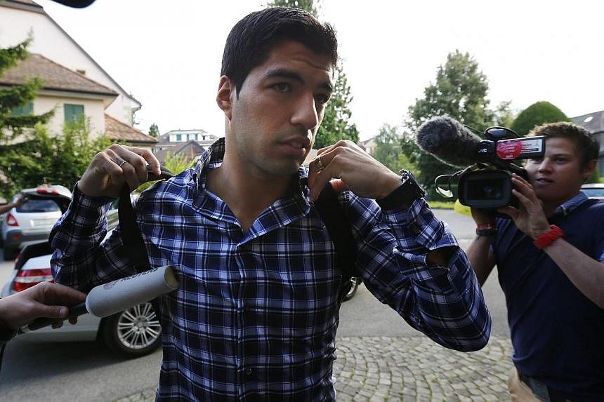 Uruguayan striker Luis Suarez arrives for a hearing at the Court of Arbitration for Sport (CAS) in Lausanne on Aug 8, 2014.&nbsp;The Court of Arbitration for Sport (CAS) began its hearing on Friday, Aug 8, 2014, into Suarez's appeal against his ban f