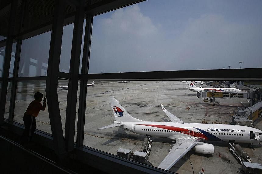Malaysia Airlines will be de-listed ahead of a major restructuring following the twin disasters of MH370 and MH17, said its majority shareholder Khazanah Nasional. -- PHOTO: REUTERS
