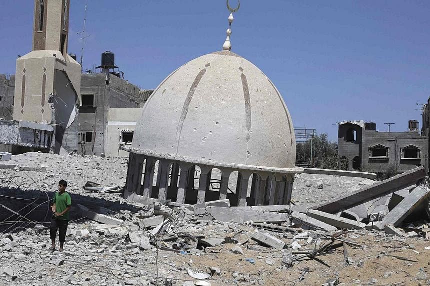 What is left of a mosque in the southern Gaza Strip on Wednesday after Israeli shelling and air strikes. UN schools in Gaza, which shelter more than 250,000 refugees, and their hospitals have also suffered hits.