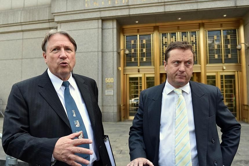 Lawyers Jerome H. Mooney (left) and Vincent S. Verdiramo speak outside US Federal Court after their client Indonesian-born wine dealer Rudy Kurniawan was sentenced to 10 years in prison August 7, 2014 in New York. Kurniawan was found guilty last year