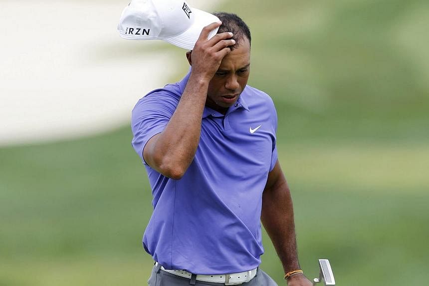 Tiger Woods of the US reacts after finishing his play in the first round of the PGA Championship at Valhalla Golf Club in Louisville, Kentucky, August 7, 2014. Woods looked less like a 14-time major champion and more like a 38-year-old with a recent 