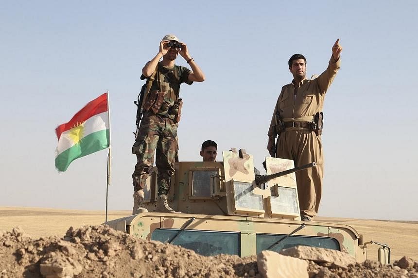Kurdish peshmerga troops participate in an intensive security deployment against Islamic State militants on the front line in Khazer on Aug 8, 2014.&nbsp;Unites States President Barack Obama on Saturday, Aug 9, 2014, vowed to continue air strikes aga