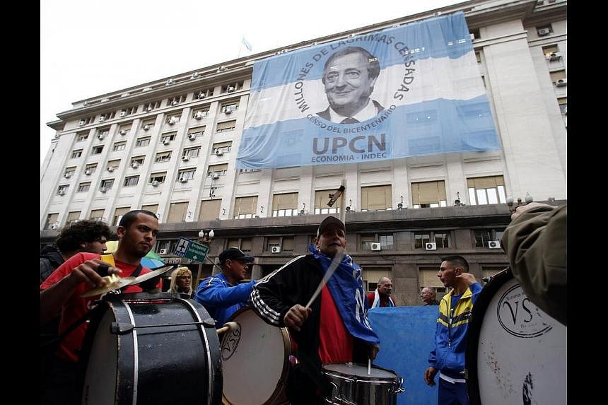 Pro-government demonstrators beating drums in front of the Economy Ministry in Buenos Aires on July 31. US Judge Griesa's ruling - preventing Argentina from paying its creditors - encourages usurious behaviour, threatens the functioning of internatio