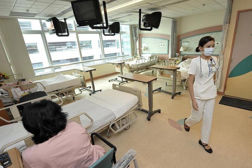 A nurse and a patient in Class B1 ward at Changi General Hospital. -- PHOTO: ST FILE