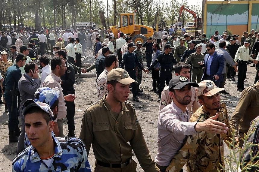 Iranian security forces secure the scene of a plane crash as emergency personnel search for survivors near Tehran's Mehrabad airport on August 10, 2014.&nbsp;A civilian airliner crashed moments after it took off from Teheran on Sunday, killing 39 peo