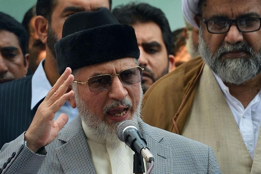 Canadian-based cleric Tahir-ul-Qadri speaks to media in the eastern Pakistani city of Lahore on August 9, 2014.&nbsp;Pakistani police on Sunday charged a populist, anti-government cleric with murder after a policeman was killed during clashes with hi