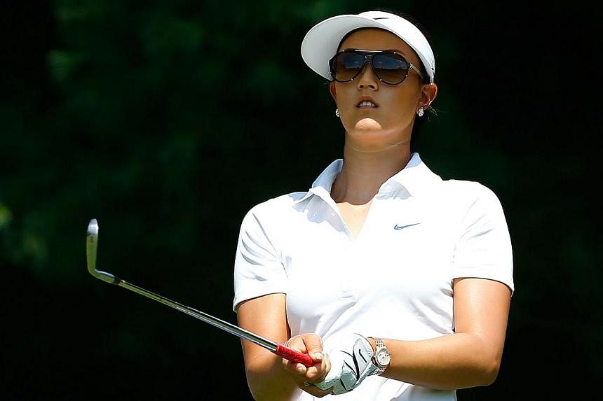 Michelle Wie watches her tee shot on the third hole during the first round of the Meijer LPGA Classic at Blythefield Country Club on Aug 7, 2014, in Belmont, Michigan.&nbsp;American golfer Michelle Wie could miss up to five weeks of the LPGA Tour aft