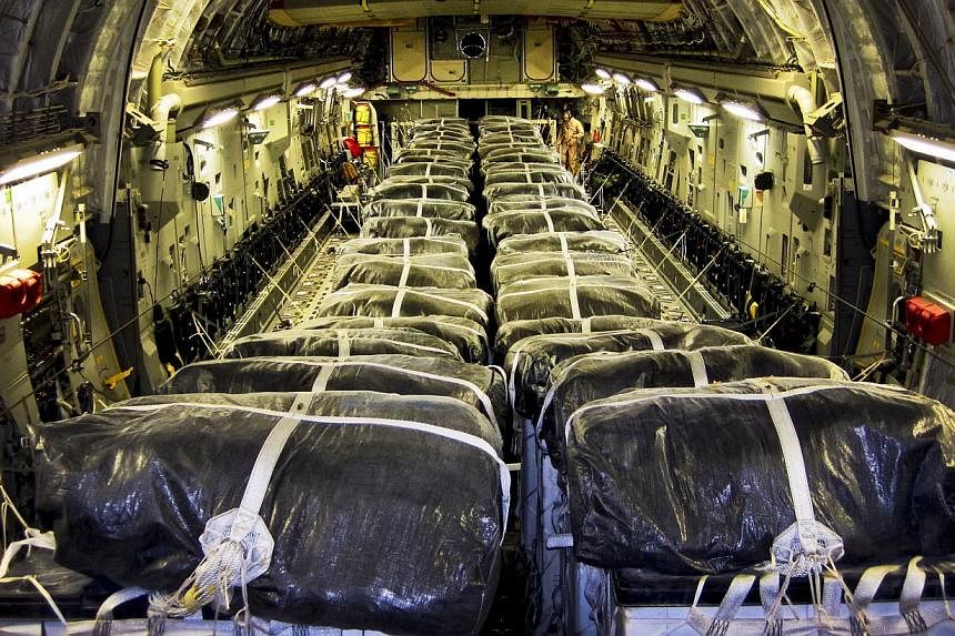 In this image released by the US Air Force, straps secure water bundles aboard a C-17 Globemaster III before a humanitarian airdrop over Iraq on Aug 8, 2014. -- PHOTO: AFP