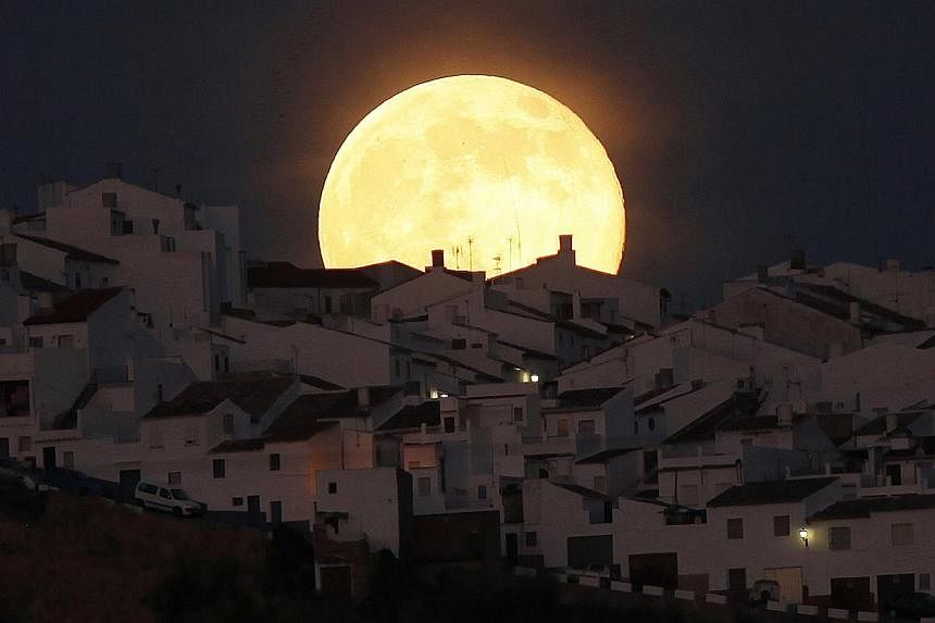 The Supermoon rises over houses in Olvera, in the southern Spanish province of Cadiz. -- PHOTO: REUTERS&nbsp;